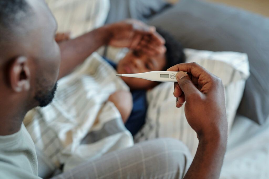Person taking a child's temperature