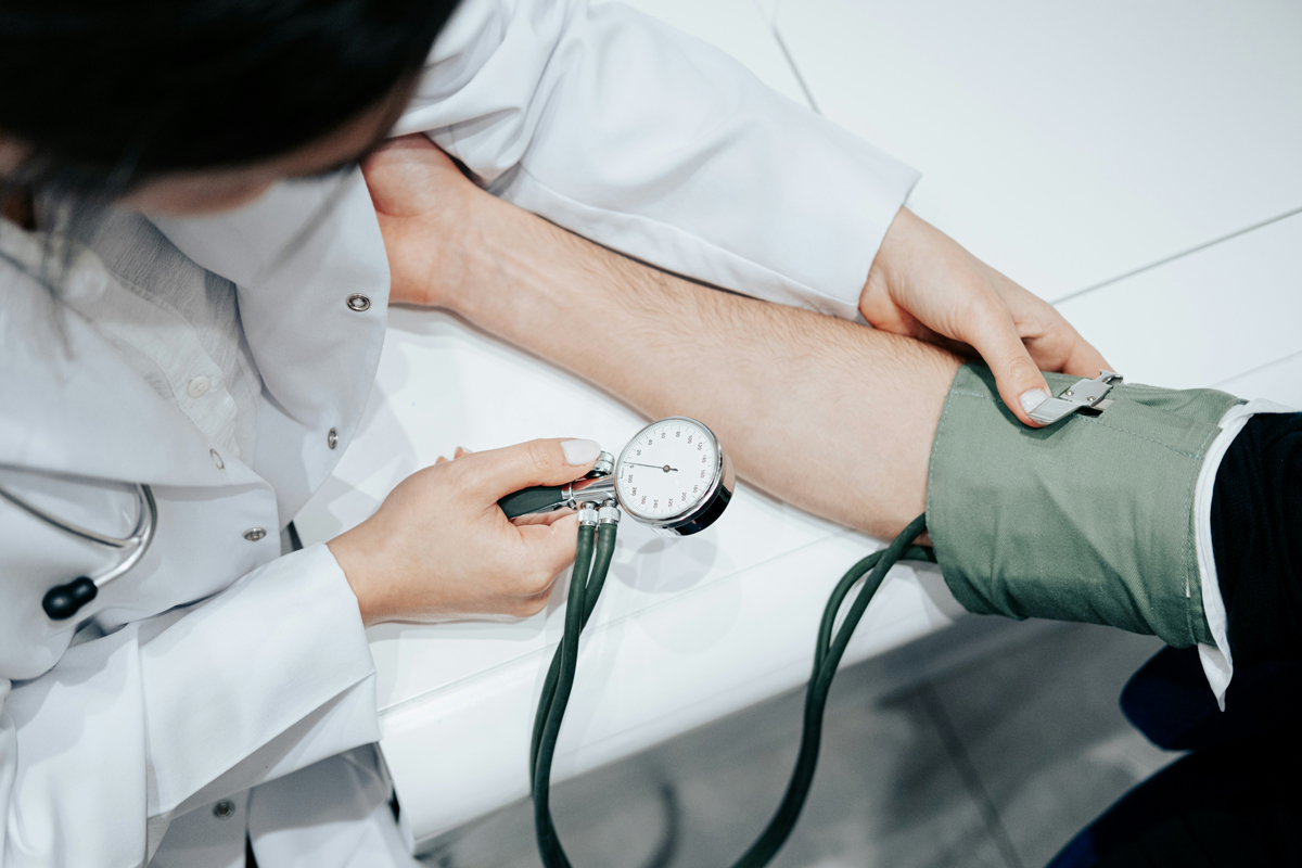 Doctor taking patient's blood pressure
