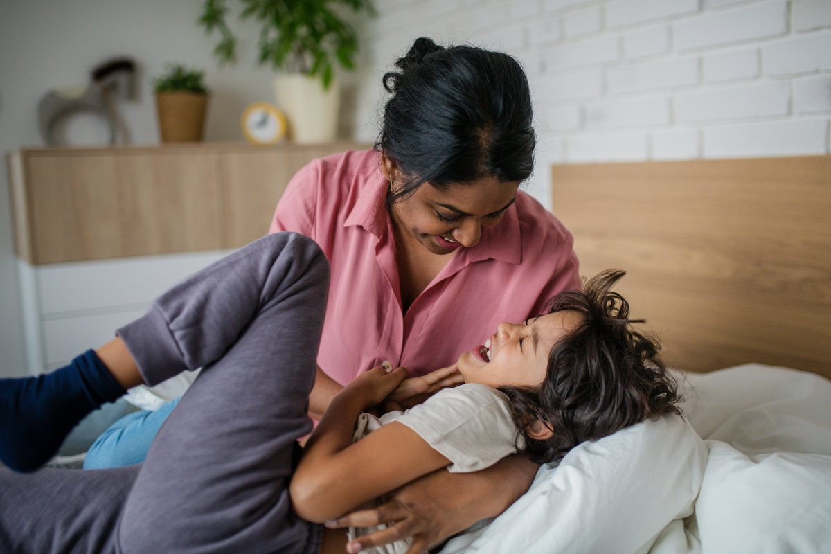 Adult tickling a child