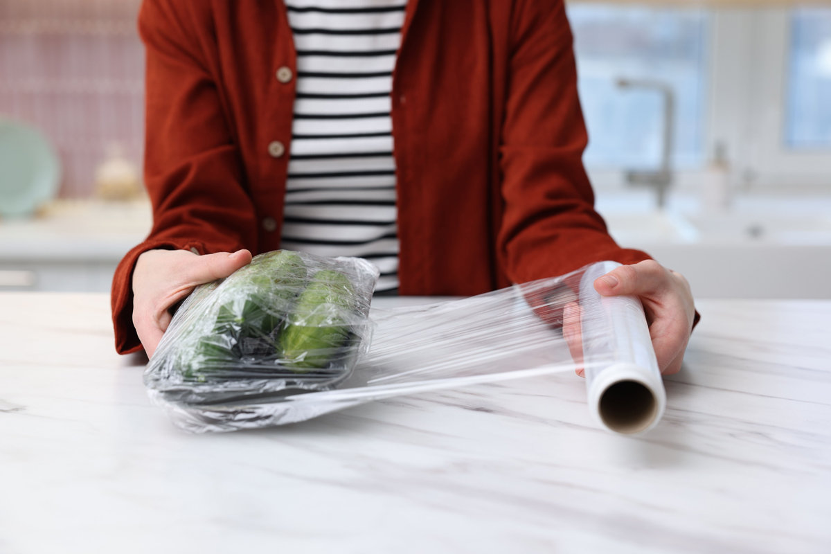 Person wrapping food with cling wrap