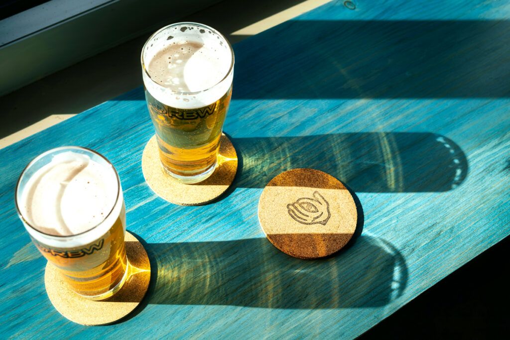 Two pints of beer and a coaster