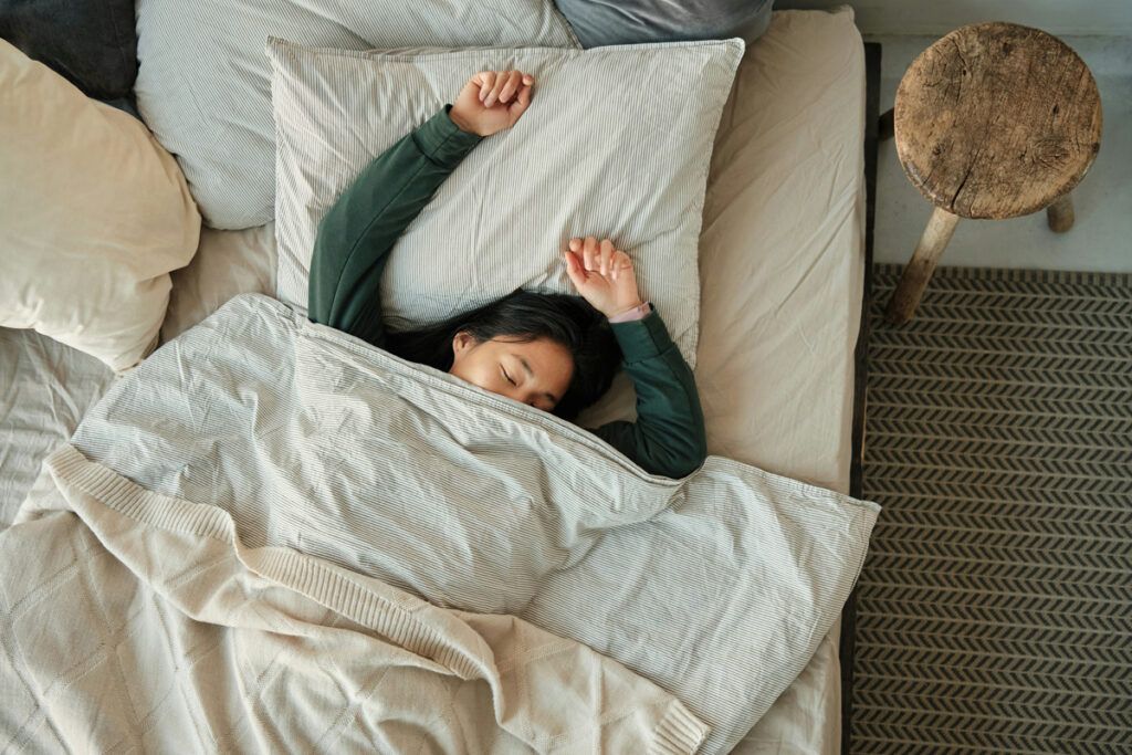 Person in bed stretching
