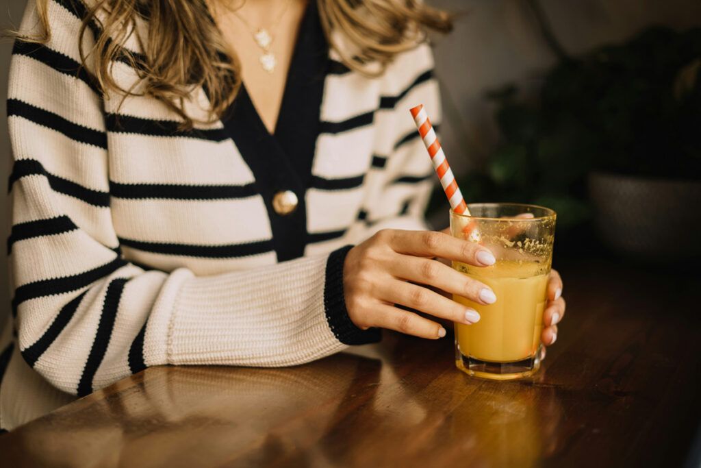 Glass with orange juice and straw
