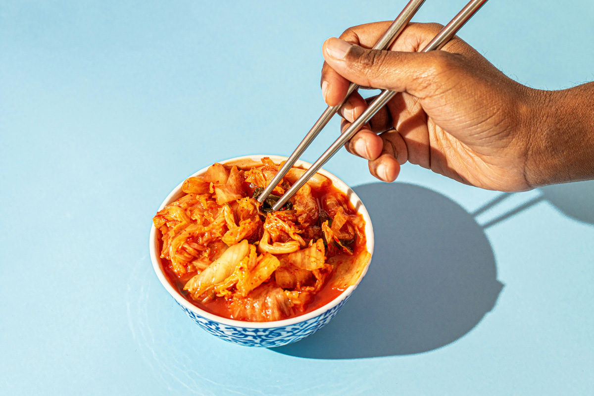 Eating spicy food with chopsticks