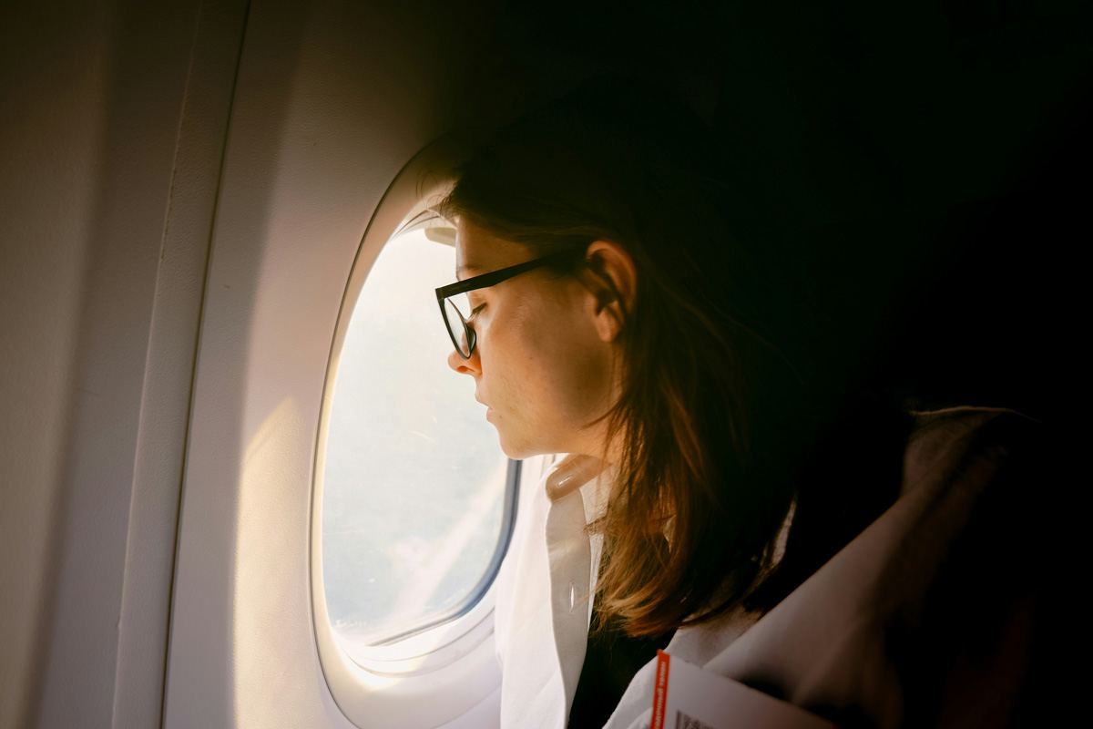 Passenger looking out a plane window