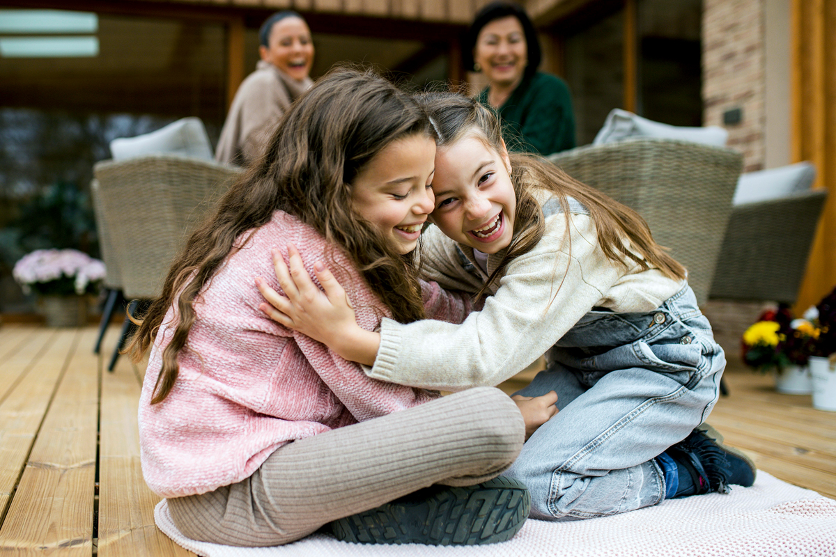 Two children hugging at a family gathering