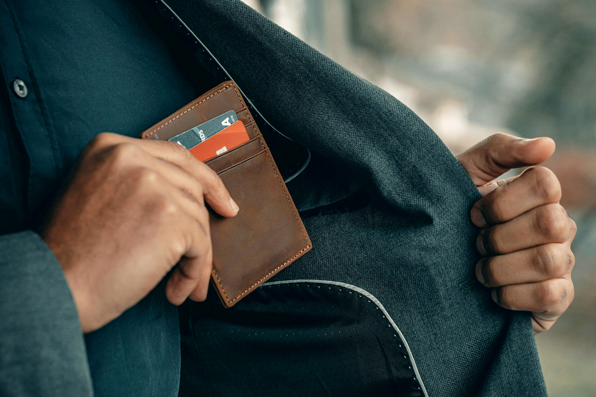 Person taking out their wallet and credit cards