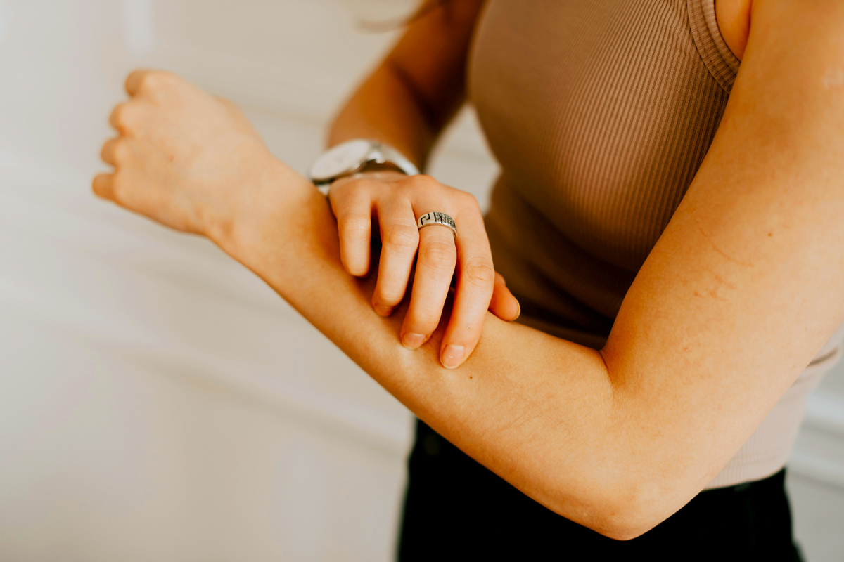 Person scratching their forearm