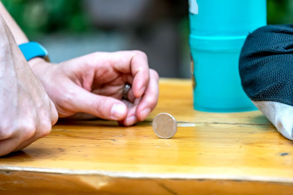 A hand spinning a coin