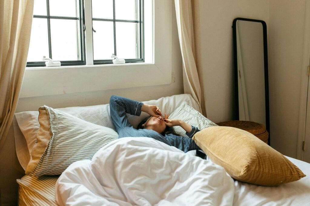 Person in bed with the sun up