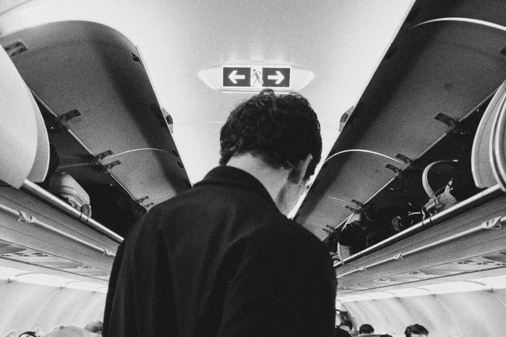 Person walking down an airplane aisle