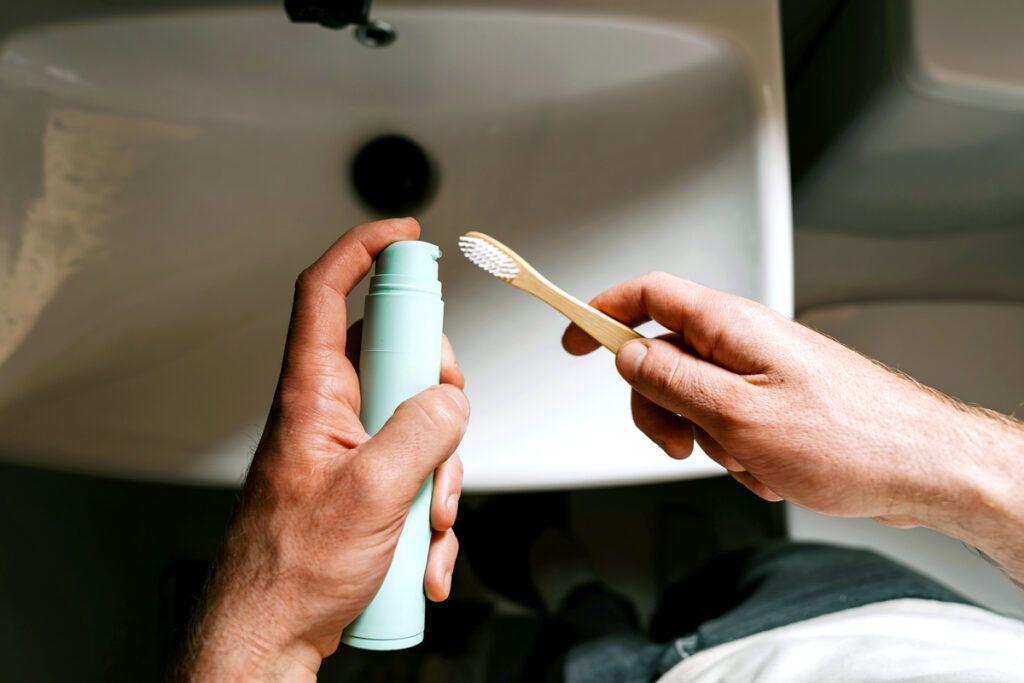 Applying toothpaste to toothbrush