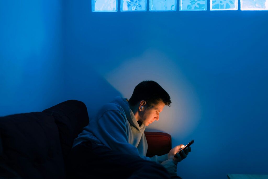 Person looking at screen at night