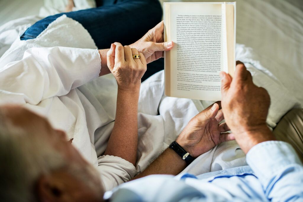 Two people sharing a book