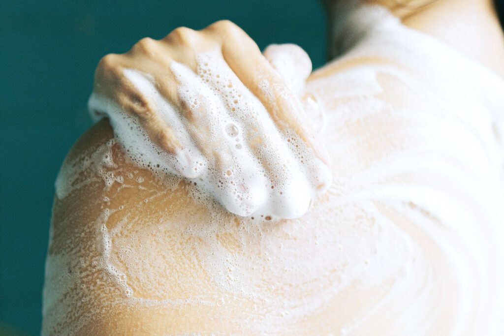 Using body wash on shoulder