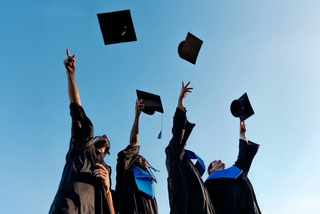Graduates tossing their caps