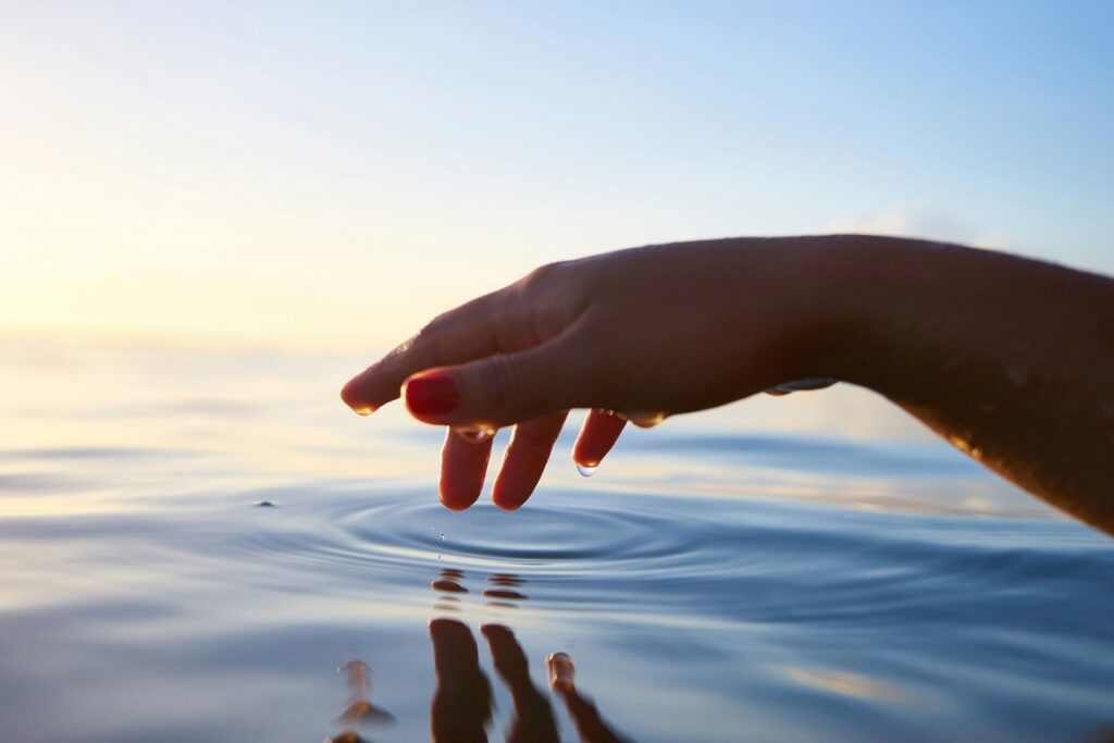 Hand sticking out touching water